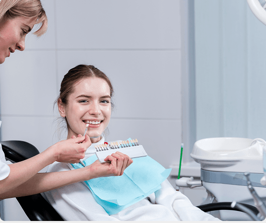 Dental hygienist cleaning a patient's teeth