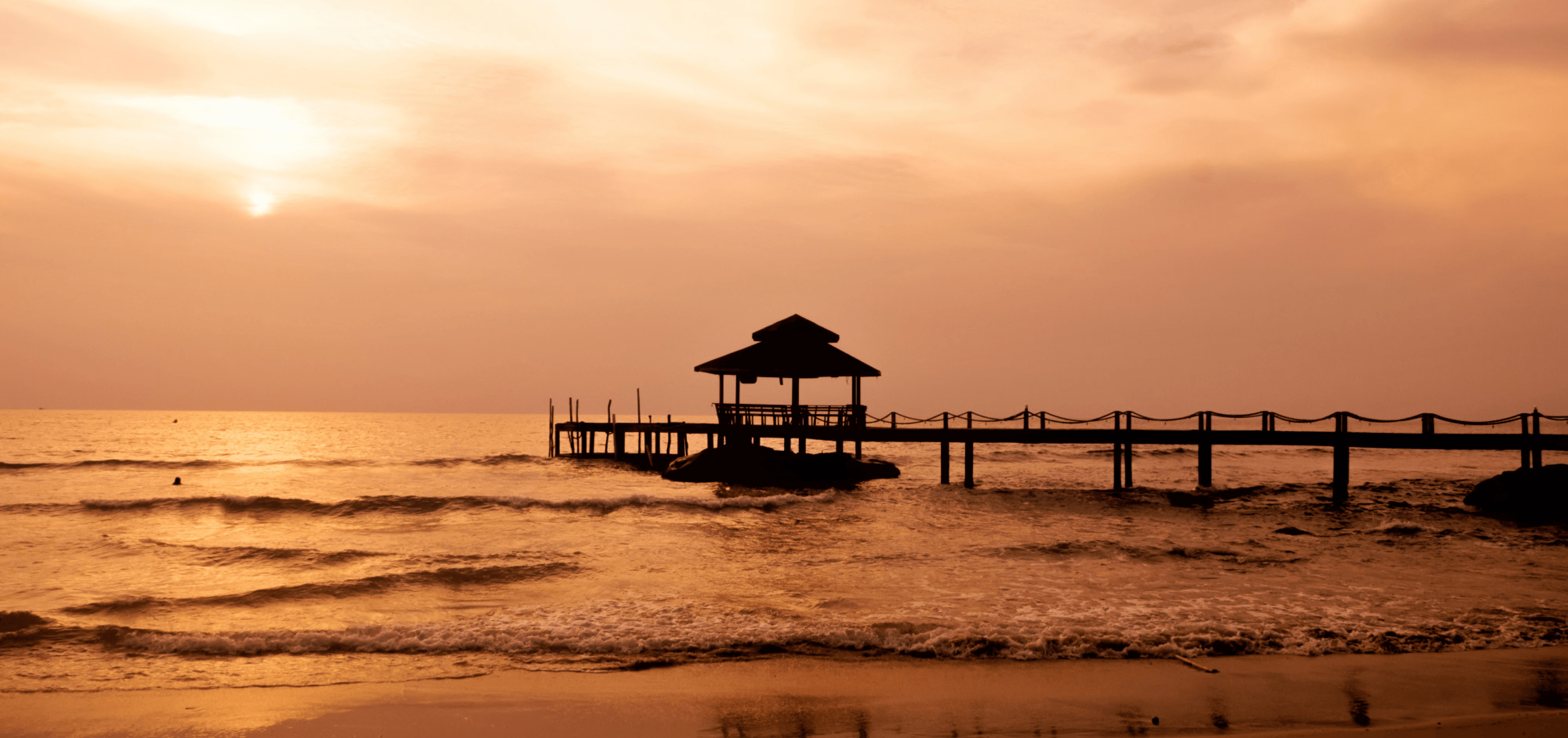 Pier and gazebo over the water at sunset