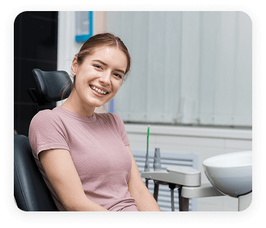 Smiling patient sitting in a dental chair