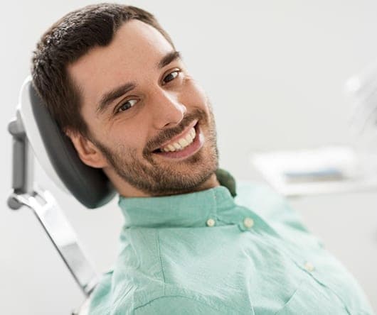 Smiling man in the dental chair