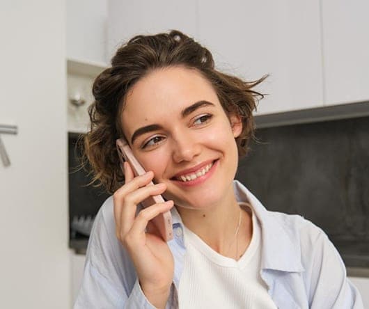Woman smiling while talking on the phone